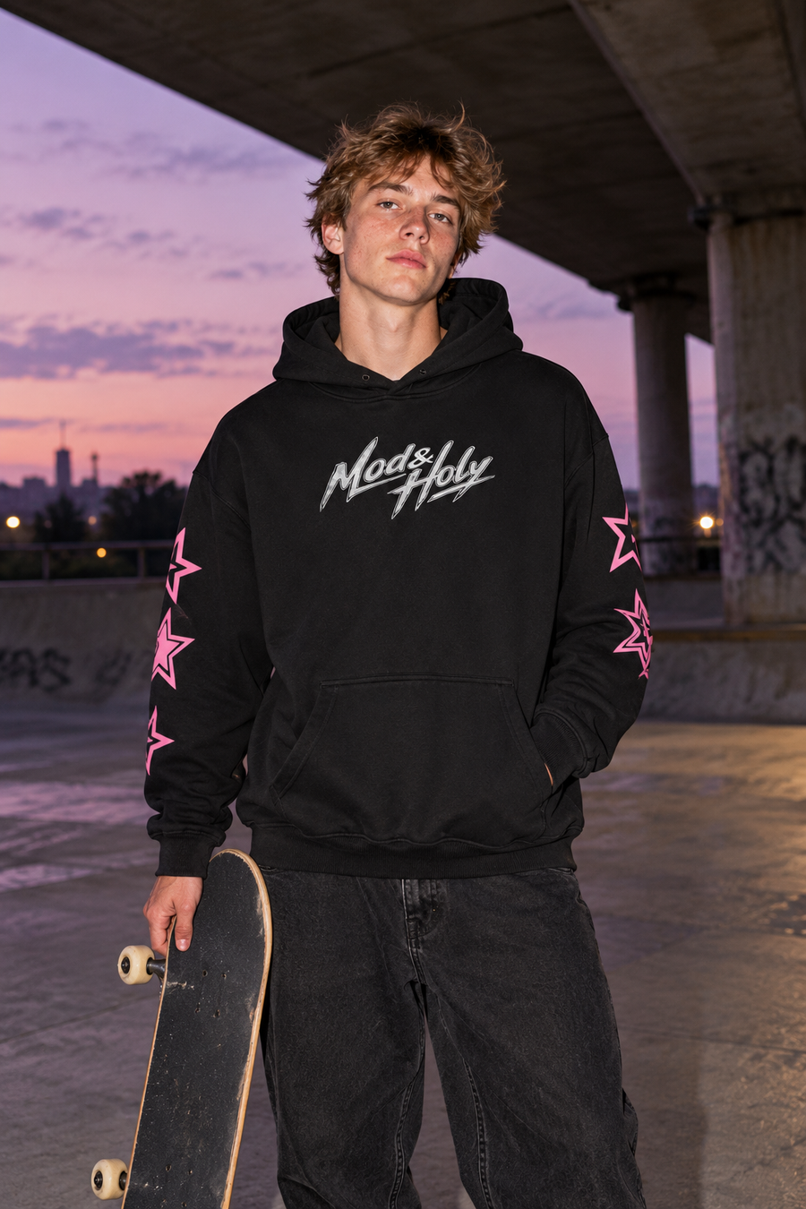 Young adult skater wearing the pink star-sleeve hoodie.